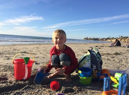 Toothless boy at the beach