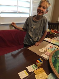 This kid was kickin' dad's butt on Monopoly!